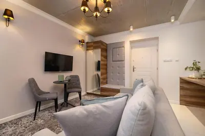 a living room with a couch and a table at One bedroom apartment- Rakowicka 6 in Kraków