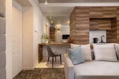 a living room with a couch and a kitchen at One bedroom apartment- Rakowicka 6 in Kraków