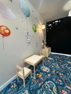 a childs room with a table and a blackboard at Dom z Wanną z Hydromasażem i Sauną - agroturystyka in Mucharz