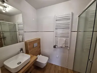 a bathroom with a sink and a toilet and a shower at Dom z Wanną z Hydromasażem i Sauną - agroturystyka in Mucharz