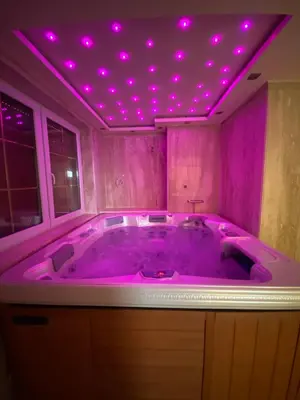 a purple bathroom with a tub with purple lights on it at Dom z Wanną z Hydromasażem i Sauną - agroturystyka in Mucharz