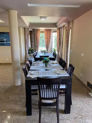 a dining room with a long table and chairs at Dom z Wanną z Hydromasażem i Sauną - agroturystyka in Mucharz