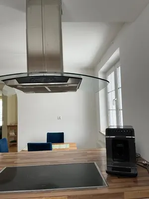 a kitchen with a hood over a table with a stove at B-Willa Słopnice basen & jacuzzi, sauna in Słopnice