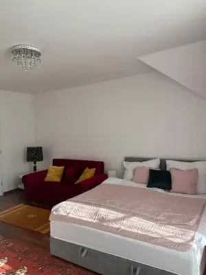 a bedroom with a large bed and a couch at B-Willa Słopnice basen & jacuzzi, sauna in Słopnice
