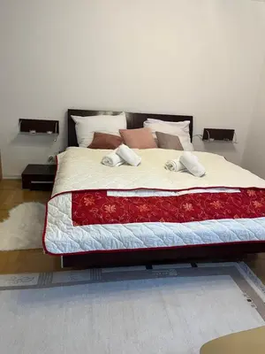 a bed with two towels on it in a bedroom at B-Willa Słopnice basen & jacuzzi, sauna in Słopnice