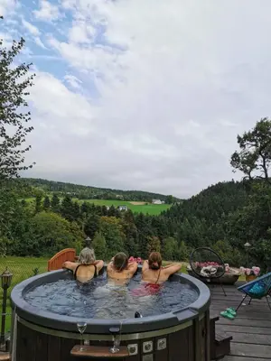 a group of three women in a hot tub at Pod Wysokim Niebem in Wysokie