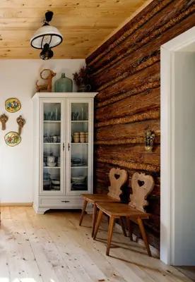 a room with a wooden wall with a table and chairs at Pod Wysokim Niebem in Wysokie