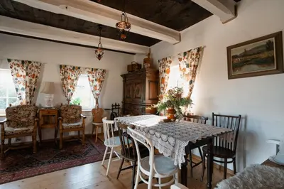 a dining room with a table and chairs at Pod Wysokim Niebem in Wysokie