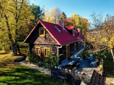 a small wooden house with a red roof at Pod Wysokim Niebem in Wysokie