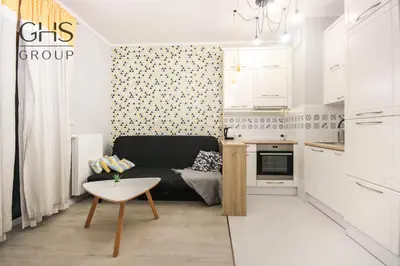 a small living room with a couch and a table at Great apartment with a garden in the city center, Old Town in Kraków