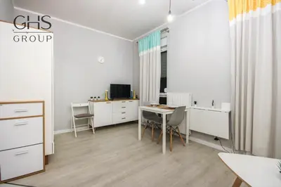 a white room with a desk and a table with chairs at Great apartment with a garden in the city center, Old Town in Kraków