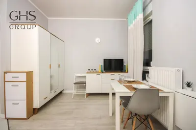 a white office with a desk and a chair at Great apartment with a garden in the city center, Old Town in Kraków