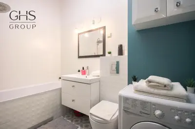 a bathroom with a sink and a washing machine at Great apartment with a garden in the city center, Old Town in Kraków