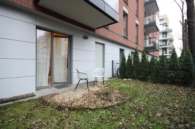 a chair sitting in a yard next to a building at Great apartment with a garden in the city center, Old Town in Kraków