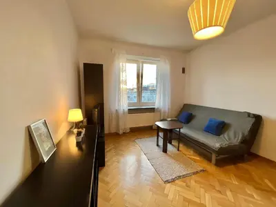 a living room with a couch and a table at City Center Apartment in Kraków