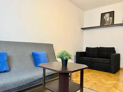 a living room with a couch and a table at City Center Apartment in Kraków