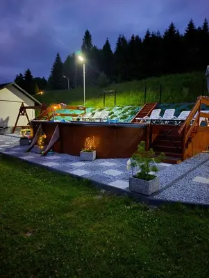 a house on the side of a grassy hill at Zawojskie Spanie in Zawoja