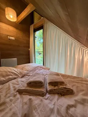 a bedroom with a bed with towels on it at Beskidzkie Wyspy in Tenczyn