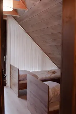 a room with two bunk beds and a ceiling at Beskidzkie Wyspy in Tenczyn