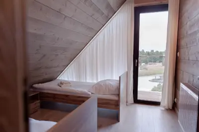 a room with a bed and a large window at Beskidzkie Wyspy in Tenczyn