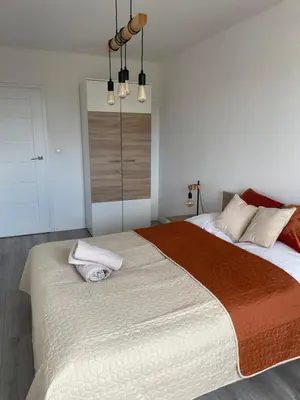 a bedroom with a large bed with two pillows on it at Przestronne mieszkanie Kraków in Kraków