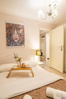 a bedroom with a large bed with a table on it at Piasek Apt - Top Location, Patio, Tram&Bus nearby - by Rentujemy in Kraków