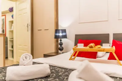 a bedroom with a bed with a tray of food on it at Piasek Apt - Top Location, Patio, Tram&Bus nearby - by Rentujemy in Kraków