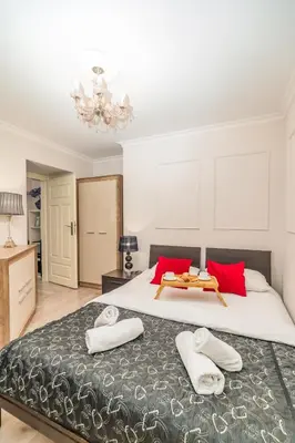 a bedroom with a large bed with red pillows at Piasek Apt - Top Location, Patio, Tram&Bus nearby - by Rentujemy in Kraków
