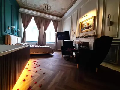 a room with a bedroom with a bed and a desk at Apartament z Jacuzzi Kraków ART Koletek in Kraków