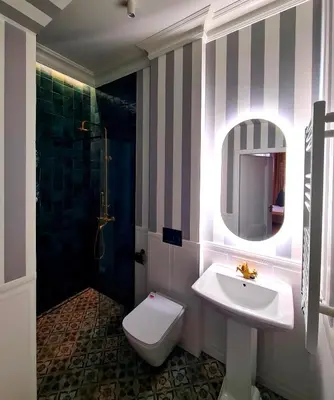 a bathroom with a sink and a toilet and a shower at Apartament z Jacuzzi Kraków ART Koletek in Kraków