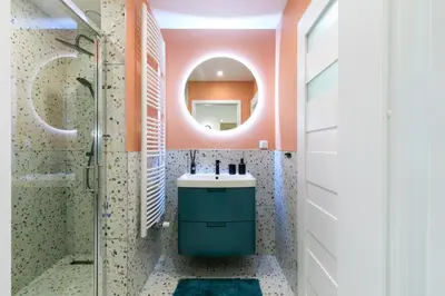 a bathroom with a sink and a mirror at Premium City Center Apartment Ariańska in Kraków