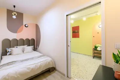 a bedroom with a bed and a mirror at Premium City Center Apartment Ariańska in Kraków