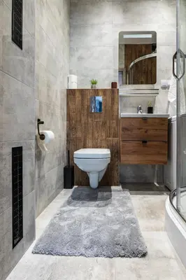 a bathroom with a toilet and a sink and a mirror at Apartamenty Astra in Oświęcim