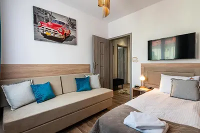 a bedroom with a couch and a red car on the wall at Apartamenty Astra in Oświęcim
