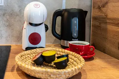 a table with a basket of food and a coffee maker at Apartamenty Astra in Oświęcim
