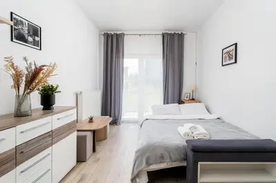 a living room with a blue couch and a table at Dębniki Pleasant Studio by BookingHost in Kraków