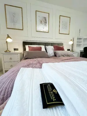 a bedroom with a bed with a book on it at Apartament Lumière in Oświęcim