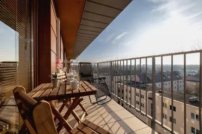 a balcony with a table and chairs on a building at Exceptional Apartment with Balcony by Noclegi Renters in Kraków