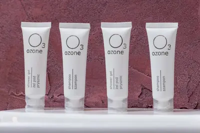 a group of four tubes of ozone cream on a shelf at Exceptional Apartment with Balcony by Noclegi Renters in Kraków