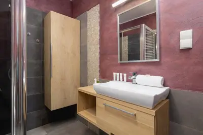 a bathroom with a white sink and a mirror at Exceptional Apartment with Balcony by Noclegi Renters in Kraków