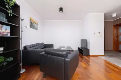 a living room with a couch and a table at Exceptional Apartment with Balcony by Noclegi Renters in Kraków