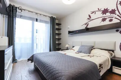 a bedroom with a bed and a large window at Beautiful apartment in the city center, Angel City in Kraków