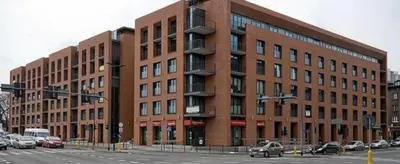 a large brick building with cars parked in front of it at Beautiful apartment in the city center, Angel City in Kraków