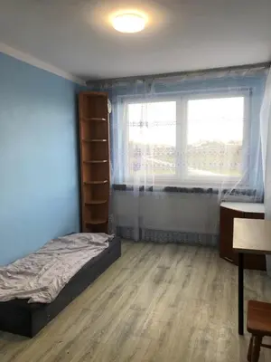 a bedroom with a bed and a window and a desk at Hostel pracowniczy in Tropiszów