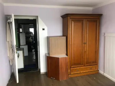 a room with a wooden cabinet next to a door at Hostel pracowniczy in Tropiszów