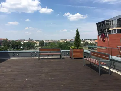 two benches sitting on the roof of a building at Apartament Nad Wisłą in Kraków