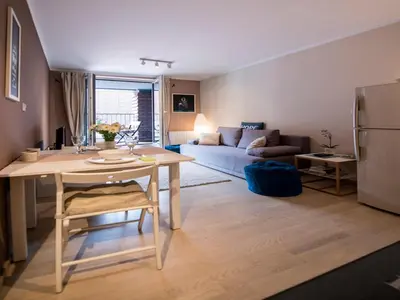 a bedroom with a large bed with two lamps at Apartament Nad Wisłą in Kraków