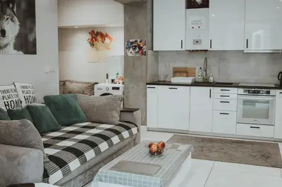 a kitchen with a refrigerator and a tv on a wall at GRAND COMFORT 3 Bedroom, 3 Bathroom, Ground Floor&Fresh Air in Kraków