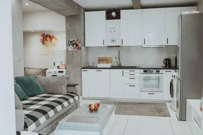a living room with a couch and a kitchen at GRAND COMFORT 3 Bedroom, 3 Bathroom, Ground Floor&Fresh Air in Kraków