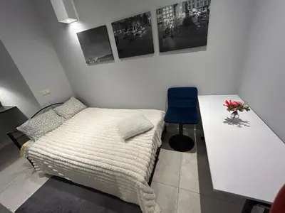 a living room with a couch and a kitchen at GRAND COMFORT 3 Bedroom, 3 Bathroom, Ground Floor&Fresh Air in Kraków